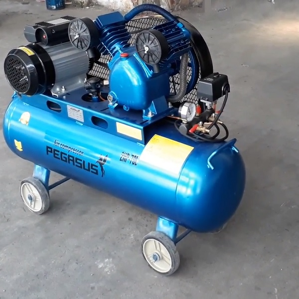 A blue air compressor on wheels

Description automatically generated